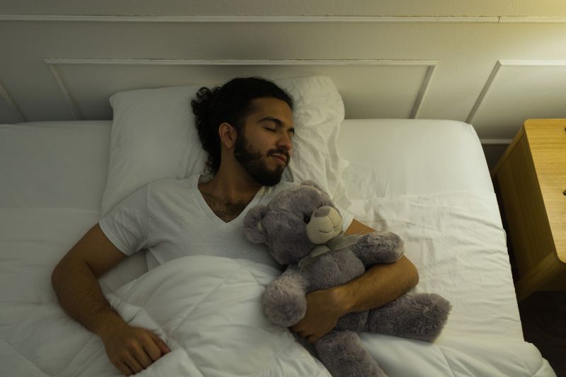 Adults can sleep with stuffed animals, too. It might even be a good thing, experts say